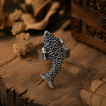 Load image into Gallery viewer, Close-up of an oxidized silver fish statement ring with engraved detailing, placed on a rustic wooden surface with warm earthy tones and dried elements.