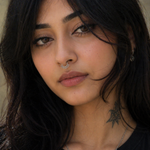 Load image into Gallery viewer, Close-up of a young woman wearing a small oxidized silver leaf design septum ring, styled in a modern minimal aesthetic with soft natural lighting.