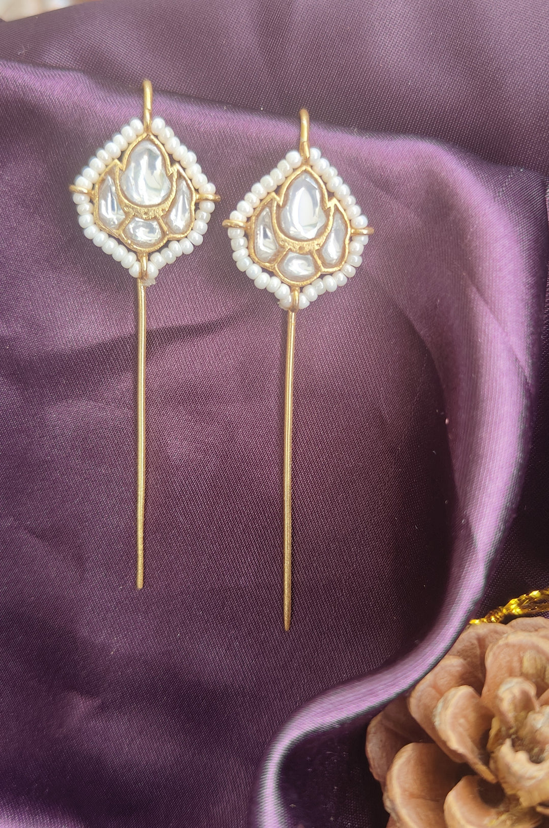 Elegant Brass Earcuffs featuring luminous Kundan stones, delicate pearl accents, and a graceful elongated silhouette