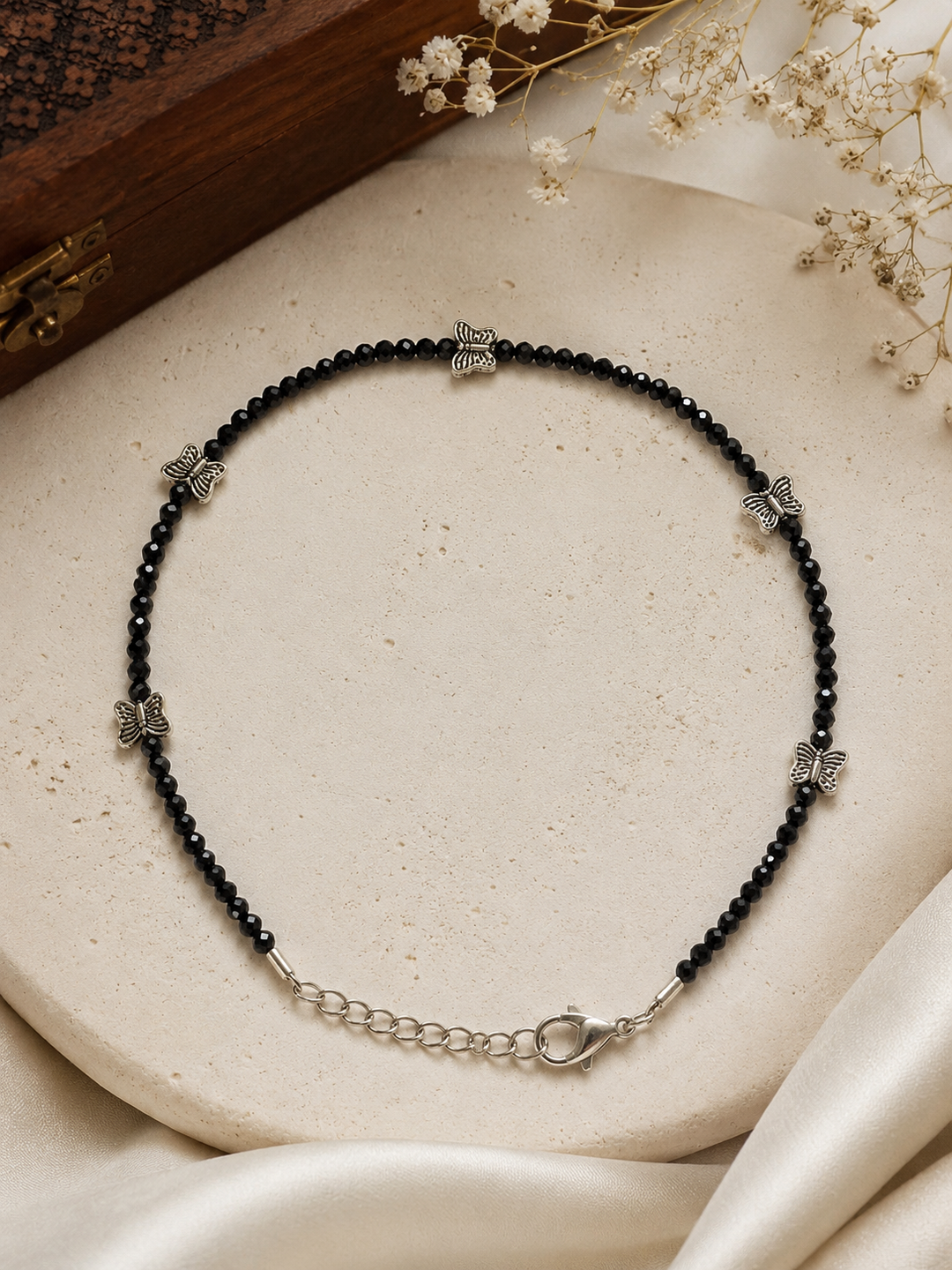 Premium oxidized silver butterfly crystal bead anklet with faceted black crystal beads, adjustable chain clasp, handcrafted boho payal for women, elegant ethnic and western ankle jewelry.